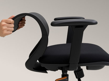 Hands flexing the ErgoStretch office chair's backrest to show its ultra-strong flexibility and resilience.
