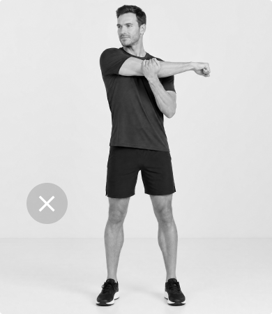 Man doing an ineffective standing arm stretch, showing the limitations of stretching without the ErgoStretch chair.