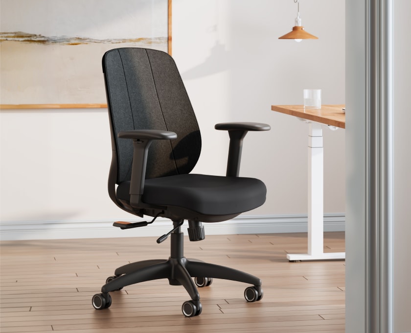 ErgoStretch office chair with fabric back cover, shown in a modern home office setting.
